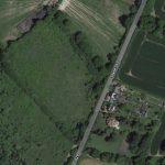 Property for sale by Auction A satellite image shows a rural landscape with a mix of fields, forests, and residential areas. A road labeled "Stane Street" runs through the center. To the right of the road near Plot 10, there are houses and cultivated fields, while the left side has mostly green open land and trees in Ockley. Presented by Palace Auctions