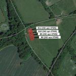 Property for sale by Auction An aerial view depicts four plots labeled B8, B9, B10, and Plot B11, each measuring 242 square meters. They are nestled in a wooded area alongside Crampshaw Lane with the postcode KT18 6BX, adjacent to a winding road and green fields. Presented by Palace Auctions