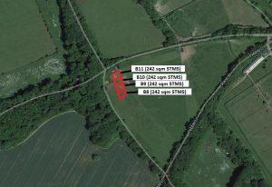 Property for sale by Auction An aerial view depicts four plots labeled B8, B9, B10, and Plot B11, each measuring 242 square meters. They are nestled in a wooded area alongside Crampshaw Lane with the postcode KT18 6BX, adjacent to a winding road and green fields. Presented by Palace Auctions