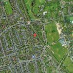 Property for sale by Auction Aerial view of a residential area in Dulwich, London, with numerous houses and streets. A red marker pinpoints 21 Glazebrook Close in the middle of the image. To the right, there are green fields, parks, and an educational institution with multiple buildings. Presented by Palace Auctions