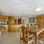 Property for sale by Auction A spacious, well-lit kitchen and dining area with light wood cabinetry and furnishings is a highlight of this Dilks Street home near Bishop DL14 9AP. The modern kitchen features an island with a sink, while the dining area includes a large table with six chairs and a decorative wooden cabinet. Presented by Palace Auctions