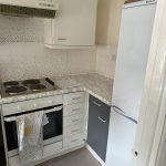 Property for sale by Auction A kitchen with white cabinets and a stove, located on Rosefield Road as part of 13 Maynard Court. Presented by Palace Auctions