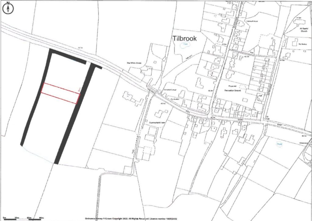 A black-and-white map of Tilbrook near Huntingdon shows residential streets, surrounding fields, and a highlighted rectangular plot of land available for sale outlined in black. Another smaller, highlighted rectangle in red lies within the larger parcel. Roads and buildings are clearly marked.