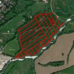 An aerial image shows a large, green area with a grid of red lines superimposed on it. The grid lines outline rectangular plots. Located near the Tonbridge Golf Centre and natural features such as Mill Stream is TN10 4LP, available for sale by auction with Palace Auctions—a great piggy bank-style investment.