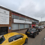 A street view shows a building with a sign for FFG Foundation and Table Top Sales on Trafalgar Street, Consett. Several cars are parked along the street, and a few pedestrians are visible in the background. This commercial investment property was sold by Palace Auctions.