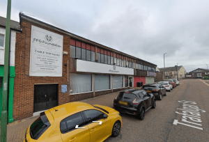 A street view shows a building with a sign for FFG Foundation and Table Top Sales on Trafalgar Street, Consett. Several cars are parked along the street, and a few pedestrians are visible in the background. This commercial investment property was sold by Palace Auctions.