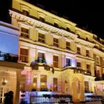 Illuminated exterior of a luxury Victorian-style hotel in Paddington, available for sale by Palace Auctions