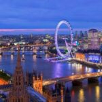 Panoramic view of London at twilight, featuring landmarks such as Big Ben, the Houses of Parliament, and the London Eye