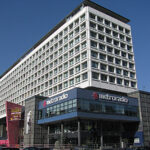 Modern multi-story building housing Metroradio under a clear blue sky