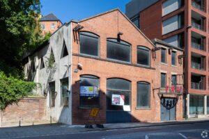 Street view of mixed architectural styles in Newcastle Upon Tyne, with buildings for sale or to let by Palace Auctions