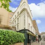 An advertisement image for a distressed hotel group for sale below market value in Central London, available through Palace Auctions