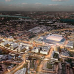 Aerial view of Tottenham an urban area with a large illuminated stadium at twilight illistrating property for sale.