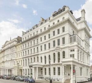 Grand, white-painted multi-story building with classic architectural details, located in Paddington, for sale by Palace Auctions