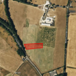 Aerial view of agricultural fields intersected by roads and pathways. A red rectangular patch highlights a section of a field. The landscape includes buildings, wooded areas, and farm structures, with roads such as Lingerfield Rd and Beech Farm Rd labeled on the map.