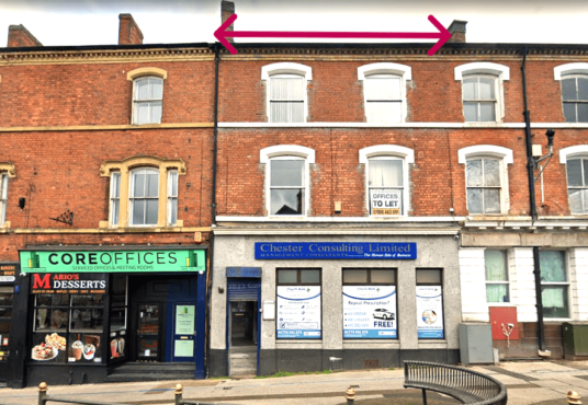 A street view of a two-story brick building with businesses on the ground level. One sign reads "MARIO's" next to "CORE OFFICES." Another sign for "Chester Consulting Limited" is visible, and a "To Let" sign is in one upper window. Pink arrows point to the roof.