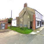 Property for sale by Auction A deteriorating former public house in Jarrow, Tyne and Wear stands at a street corner, with partially missing walls and visible structural damage. The facade shows exposed wooden beams and a significant amount of chipped plaster. Adjacent to it is a small, bricked utility structure. Presented by Palace Auctions