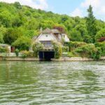 Charming two-story house by the water surrounded by lush greenery in Reading depicting the opportunity to build a similar property