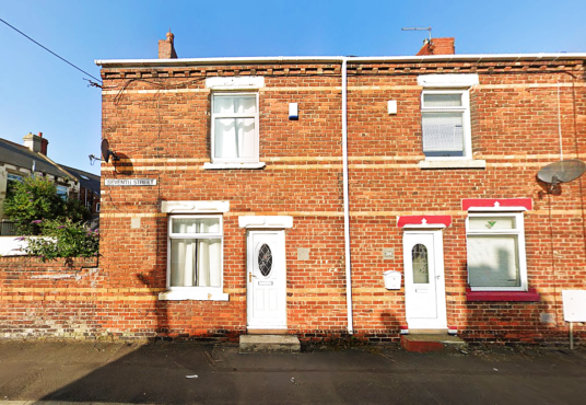 Property for sale by Auction A row of connected two-story brick houses with white-framed windows and doors. Each house has a small rectangular window on the upper floor and a larger window on the lower floor. A street sign reads "Edgeware Street. Presented by Palace Auctions