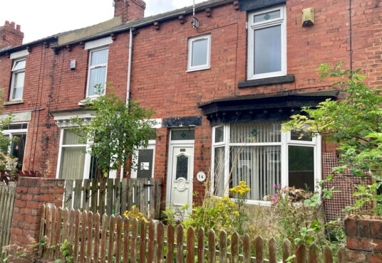Property for sale A charming Stanley 3-bed terrace on Rose Avenue, this brick family home features a small front garden with overgrown plants, a brown picket fence, white-framed windows, and a white door. Neighboring homes complete this inviting County Durham scene. Presented by Palace Auctions
