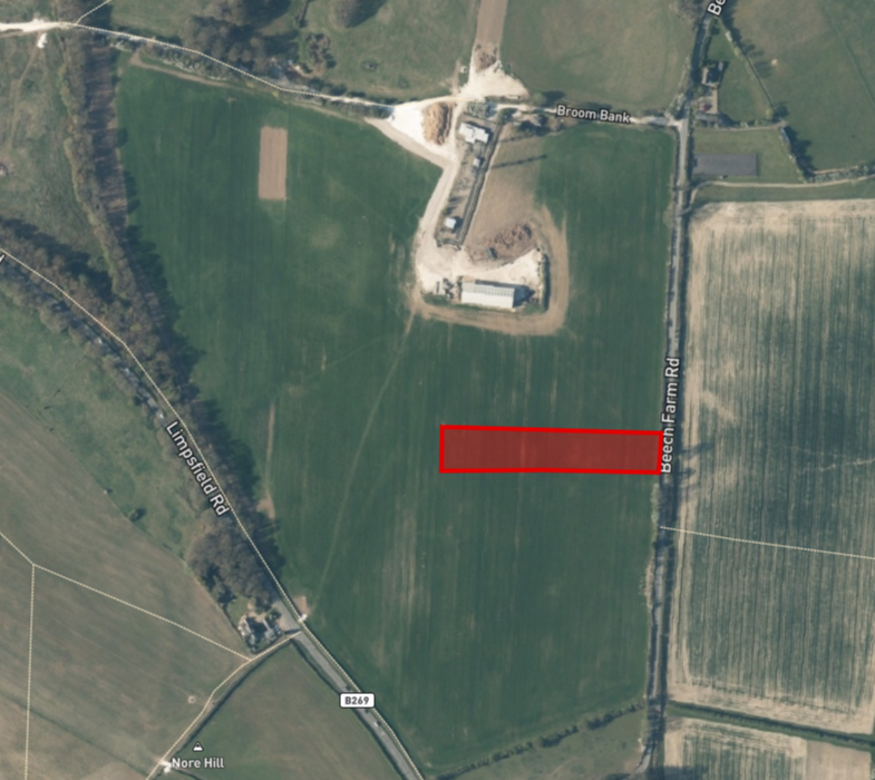 Property for sale Aerial view of green farmland intersected by roads. A rectangular red highlight marks a CR6 land plot in the central right of the field, near Beccles Farm Road, with nearby buildings and trees. Presented by Palace Auctions