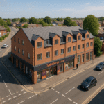 Property for sale A Sainsbury’s Local supermarket sits on the ground floor of a modern, red-brick, three-story 1-bed flat development at a street corner, with cars parked nearby and a person walking past. Trees and houses are visible in the background. Presented by Palace Auctions