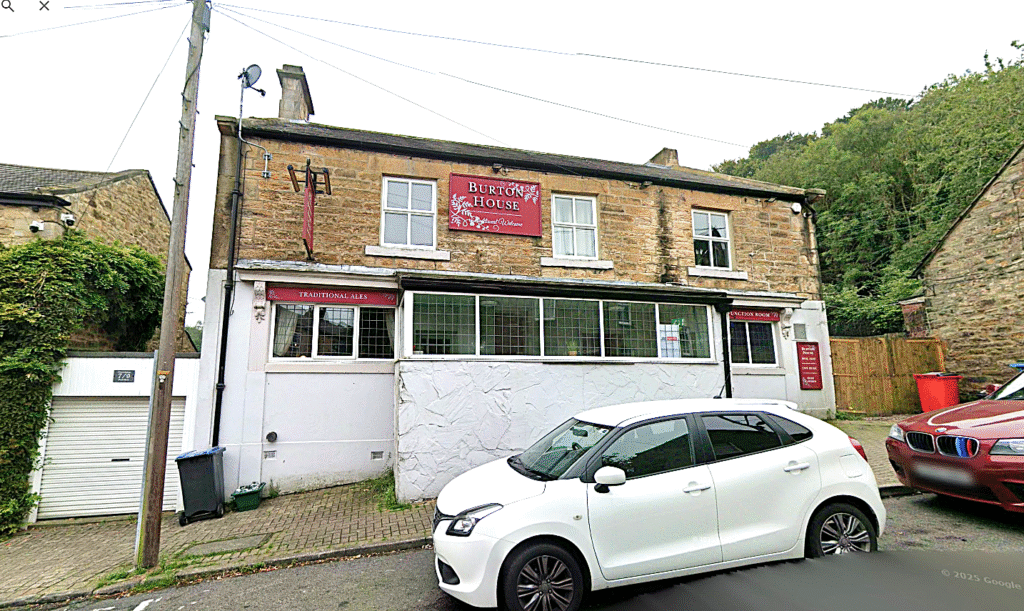 Property for sale A two-story stone building with a red sign reading "Burton House" above the entrance, this traditional public house conversion in the Newcastle area features street parking and trees nearby. Presented by Palace Auctions