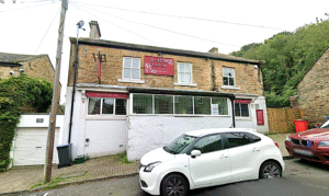 Property for sale A two-story stone building with a red sign reading "Burton House" above the entrance, this traditional public house conversion in the Newcastle area features street parking and trees nearby. Presented by Palace Auctions