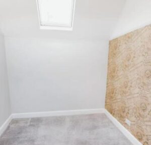 Property for sale A small, empty room with white walls, a skylight, light gray carpet, and one wall covered in patterned beige wallpaper—perfect for your next Bowdon investment property. Presented by Palace Auctions