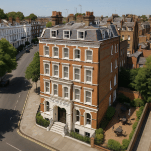 Property for sale A four-story red-brick Boutique Hotel Chelsea with white trim, named "The Overley Hotel," stands on a street corner surrounded by greenery, outdoor seating, and classic townhouses under a clear blue sky. Presented by Palace Auctions