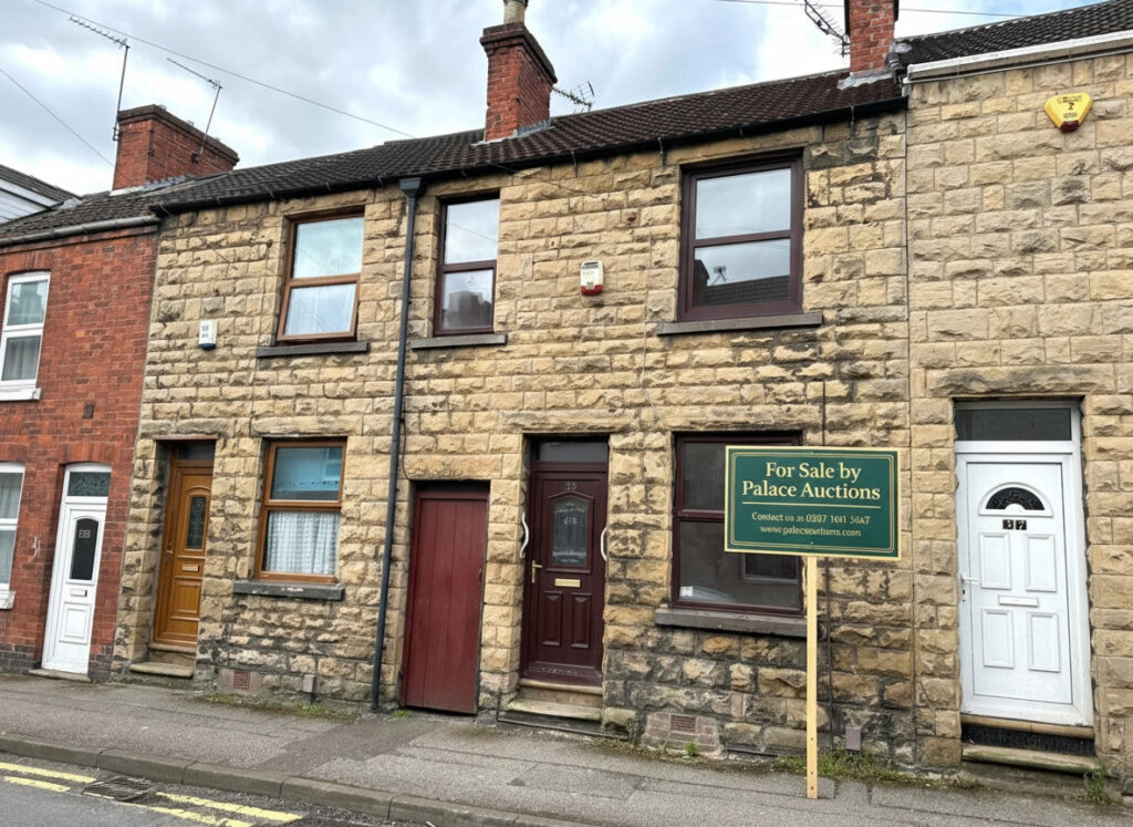 Property for sale A stone-fronted 2-bed Mansfield house with a dark brown door and window, nestled between two homes at 35 Padley Hill Mansfield, is offered as an auction property NG18 5LJ. A "For Sale by Palace Auctions" sign is displayed on the pavement. Presented by Palace Auctions