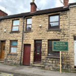 Property for sale A stone-fronted 2-bed Mansfield house with a dark brown door and window, nestled between two homes at 35 Padley Hill Mansfield, is offered as an auction property NG18 5LJ. A "For Sale by Palace Auctions" sign is displayed on the pavement. Presented by Palace Auctions