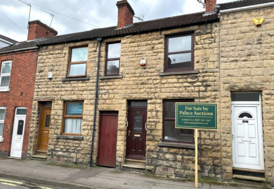 Property for sale A stone-fronted 2-bed Mansfield house with a dark brown door and window, nestled between two homes at 35 Padley Hill Mansfield, is offered as an auction property NG18 5LJ. A "For Sale by Palace Auctions" sign is displayed on the pavement. Presented by Palace Auctions