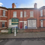 Property for sale A red brick terraced house with white trim and a bay window features a "For Sale PAKeet Auctions" sign, ideal for those seeking auction properties in Mansfield. Green bins and a blue door number 35 are visible by the entrance. Presented by Palace Auctions