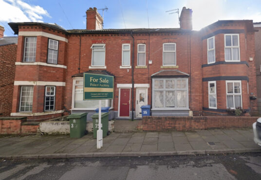 Property for sale A red brick terraced house with white trim and a bay window features a "For Sale PAKeet Auctions" sign, ideal for those seeking auction properties in Mansfield. Green bins and a blue door number 35 are visible by the entrance. Presented by Palace Auctions