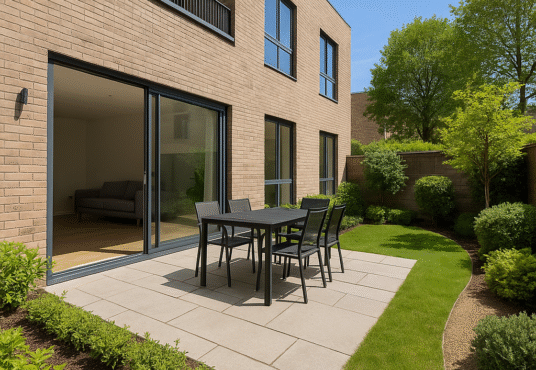 Property for sale A modern backyard patio at this E3 Bow property auction features a black outdoor dining set on stone tiles, beside a brick house with large sliding glass doors, lush grass, and landscaped plants—perfect for this stylish 2-bed flat. Presented by Palace Auctions