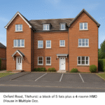 Property for sale A modern, three-story red brick apartment building with white-framed windows, ideal for HMO investment Reading seekers, featuring two white doors, a small green lawn, and paved parking on a clean street. Presented by Palace Auctions