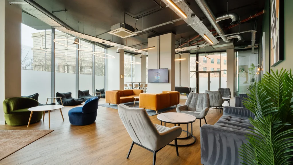 Property for sale Modern lounge area with large windows, stylish chairs, sofas, wood flooring, and contemporary lighting. Located in Langford Tower Sheffield, this bright and inviting space is perfect for those seeking modern flats in Sheffield. Presented by Palace Auctions