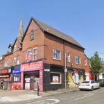 Property for sale A red-brick corner building with shops on the ground floor, including "Chic A Licious" with a bright pink sign, sits on Stockport Road Levenshulme. A mural of a woman's face decorates the side wall, making it an appealing Levenshulme investment property. Presented by Palace Auctions