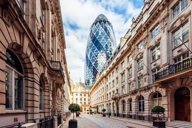 Property for sale A narrow street in London lined with historic stone buildings, with the glass-covered Gherkin skyscraper towering in the background—capturing the allure that’s driving US and Middle Eastern buyers to Auctions London in 2025. Presented by Palace Auctions