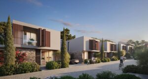 Property for sale Modern two-story houses, like Morea Coral Bay villas, with large windows and wooden shutters line a tree-lined street at sunset; people walk, a child bikes, and cars are parked in driveways surrounded by greenery. Presented by Palace Auctions