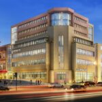 Property for sale A modern, multi-story office building with large windows and "CO-OPERATIVE" signs is illuminated at dusk in Huddersfield HD1, as cars pass by. To the left stands an ornate historic clock tower, near new 121-bed student accommodation Huddersfield offers. Presented by Palace Auctions