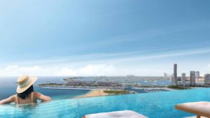 Property for sale A person in a sunhat relaxes in an infinity pool overlooking the Dubai Marina skyline and marina, with clear blue skies, sandy beaches, and a stunning sea view visible in the distance. Presented by Palace Auctions