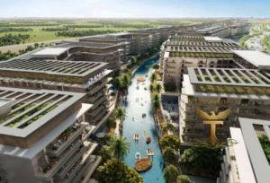 Property for sale Aerial view of modern waterfront flats with rooftop gardens lining a canal in Dubai Investment Park 2, where people kayak and relax. Palm trees and walkways border the waterway. A gold "Transparency Real Estate" logo appears in the lower right corner. Presented by Palace Auctions