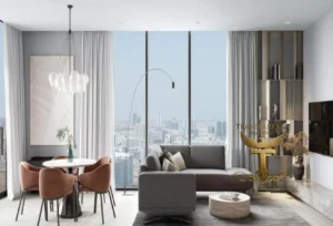 Property for sale Modern living room with large windows showing a city view at Ra1n Residence JVC flat—featuring a grey sofa, round dining table, unique pendant light, minimalist decor, shelves, and floor lamp—perfect for your luxury JVC smart flat investment in Dubai 2026. Presented by Palace Auctions