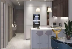 Property for sale Modern kitchen with white cupboards, an island with bar stools, pendant lights, and built-in appliances. Enjoy luxury living in Jumeirah Village Circle at Ra1n Residence JVC flat, with a dining area featuring blue chairs and plants. "Transparency Real Estate" logo overlaid. Presented by Palace Auctions