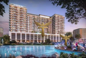 Property for sale A modern, multi-storey apartment complex labelled “DAMAC” overlooks a large pool with fountains. Residents at DAMAC Riverside Views enjoy relaxing by the Capri 2 poolside, surrounded by palm trees and illuminated landscaping at dusk. Presented by Palace Auctions