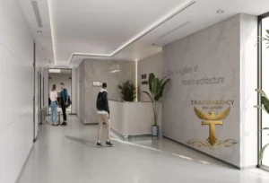 Property for sale Modern office lobby with a reception desk, potted plants, and people conversing. The wall displays “Dubai is a gallery of modern architecture.” A gold “Transparency Real Estate” logo highlights Luxury JVC Smart Apartments for Dubai investment flat 2026. Presented by Palace Auctions