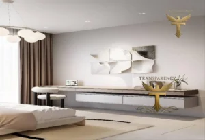 Property for sale A modern minimalist bedroom in a luxury flat at Jumeirah Village Triangle, Dubai, features a floating desk with a laptop, white chairs, abstract wall art, and a cosy bed. Soft natural light filters through sheer curtains. Two gold "TRANSPARENCY" logos overlay the image. Presented by Palace Auctions