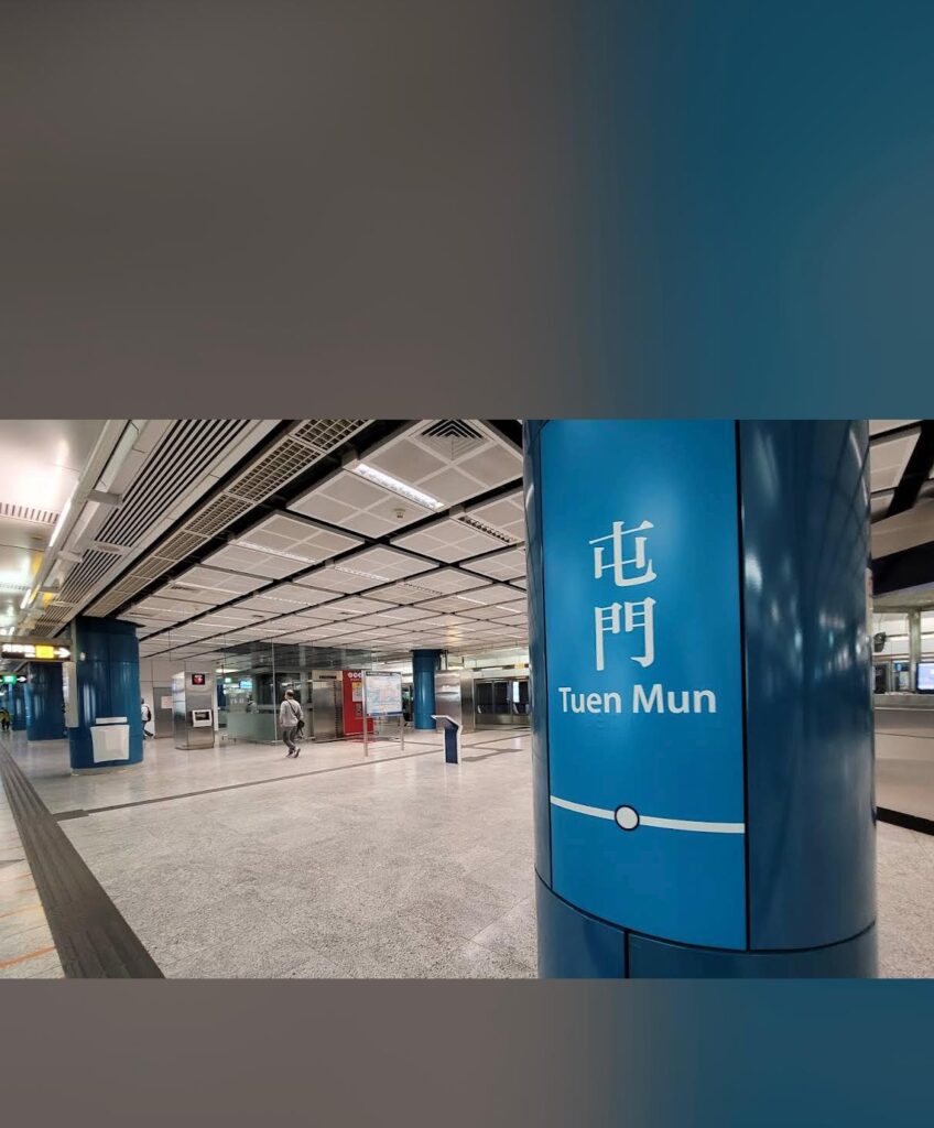 Property for sale A blue pillar at a modern underground station displays the text “Tuen Mun” in English and Chinese. The clean, spacious station hints at the convenience for those interested in a Tuen Mun flat for sale or exploring the latest Tuen Mun residential property auction. Presented by Palace Auctions