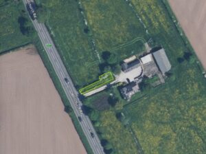 Property for sale Aerial view of a rural property along Whitefenny Rd. A small rectangular plot, highlighted in yellow near several buildings and green fields, is offered at auction for £25,000—an ideal location near the Repeater Station Chester. Presented by Palace Auctions